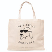 Beige tote bag with a dog illustration and the text Anti-Social Dog Owner on a white background