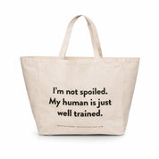 Beige large tote bag with the humorous text "I'm not spoiled. My human is just well trained. on a white background